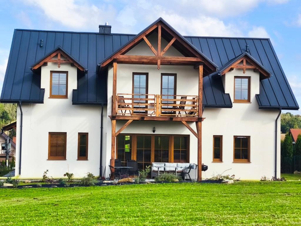 a house with a black roof at Villa Terra in Nałęczów