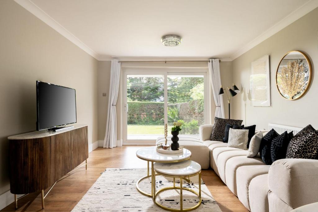 a living room with a couch and a tv at Seahaven in Sandbanks in Poole