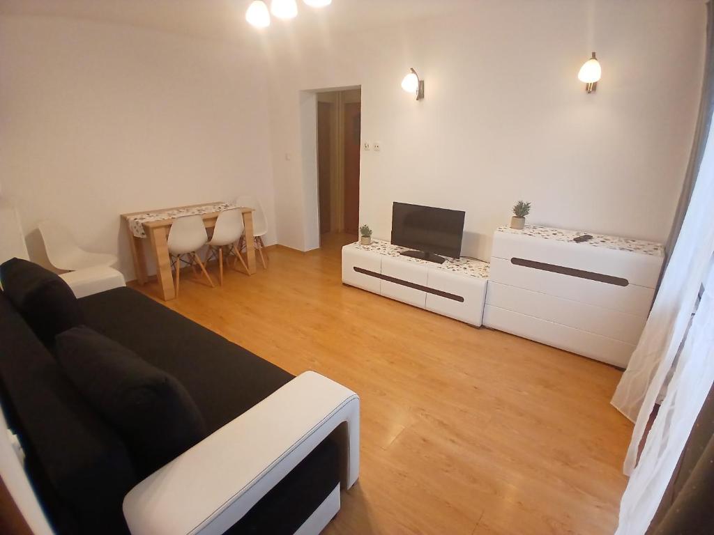 a living room with a couch and a tv at Mieszkanie Chopina Kraśnik in Kraśnik