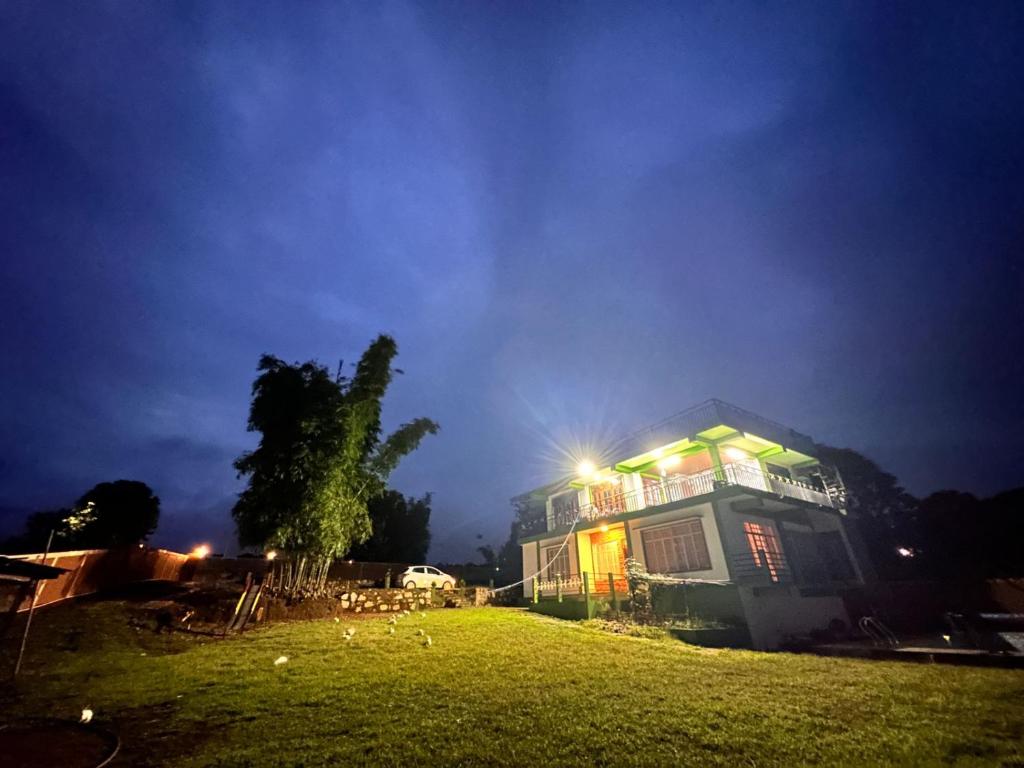 a house with a light on top of it at night at Ri Tngen - A slice of nature by the Umiam lake! in Borpāni
