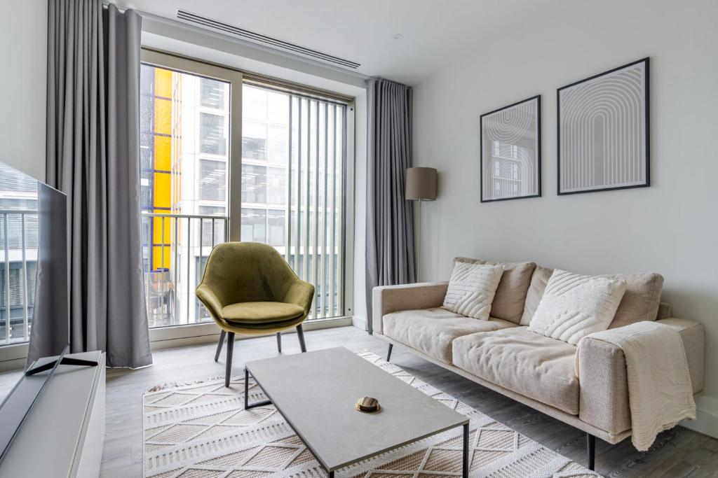 a living room with a couch and a chair at Blueground Stratford rooftop nr Olympic Park LON-690 in London