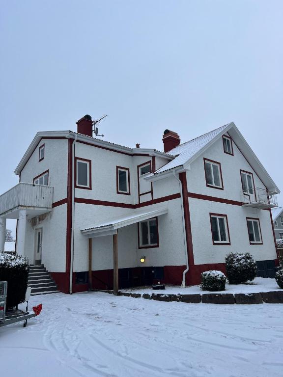 a large white house with snow on the ground at Grevgatan 4 Apt 1101 in Eksjö