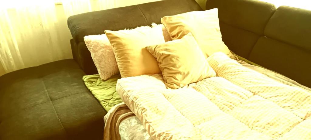 a bed with pillows on top of it at Room Lovely in Rose resort in Ljubljana in Rove