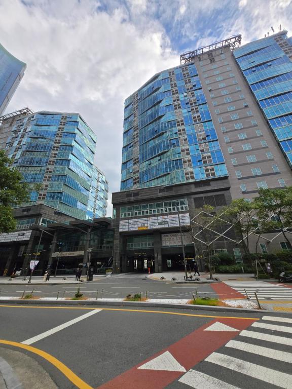 two tall buildings in a city with a street at 팔레드시즈 콘도- Pale de CZ Condo in Busan