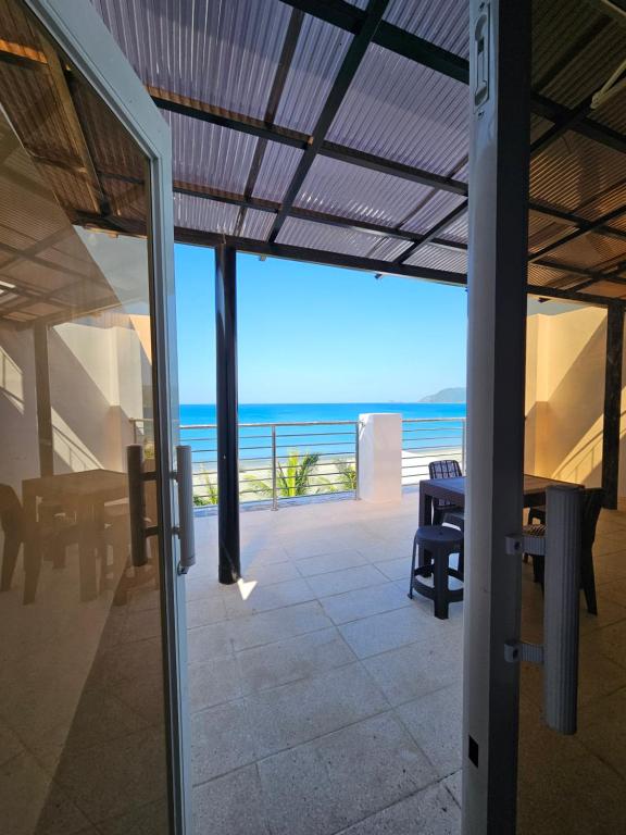 a room with a view of the ocean from a house at Gloria Beach House - Baler in Baler