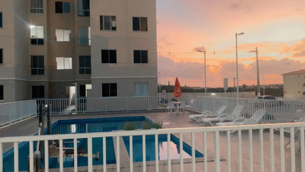 a view of a building and a swimming pool at Aconchego da day in Aracaju