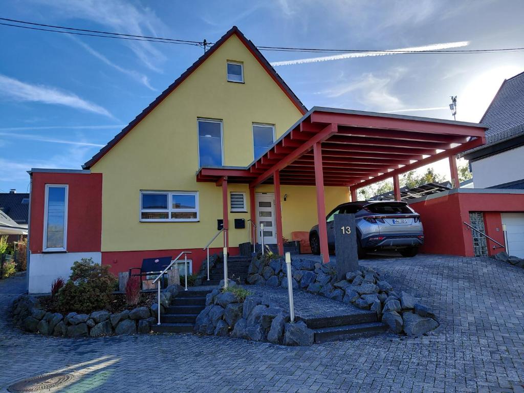 a house with a car parked in front of it at Waeller-Home in Dernbach