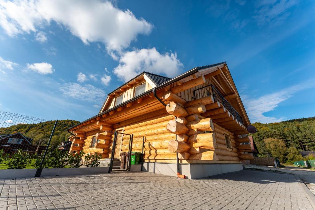 a wooden house with a gambrel roof at Wellness Zrub Valča in Stará Turá