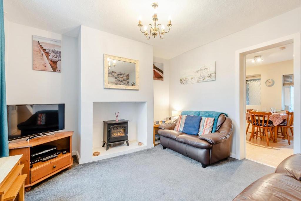 a living room with a couch and a fireplace at 2 Bed in Haverigg oc-s33747 in Haverigg