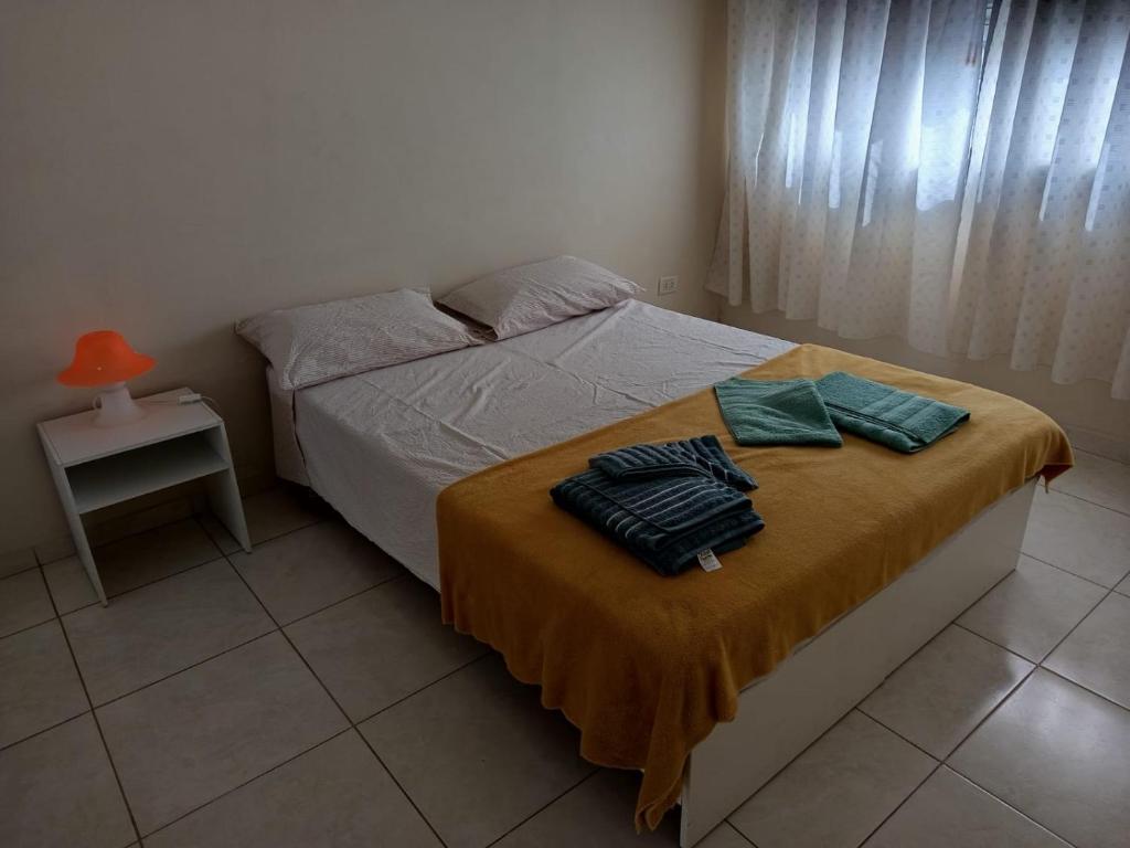a bedroom with a bed with two pillows on it at Azul y Verde in Necochea