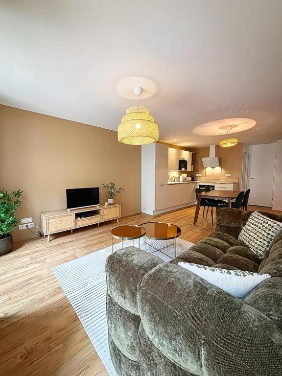 a living room with a couch and a table at Joli Perot, Confortable, centre, 5 min du port in La Rochelle