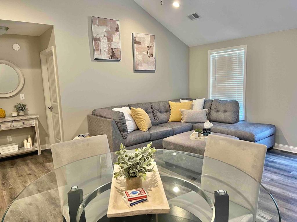 a living room with a couch and a glass table at Modern 2bd 2ba - Near I75, No Steps, Free Wifi in Richmond