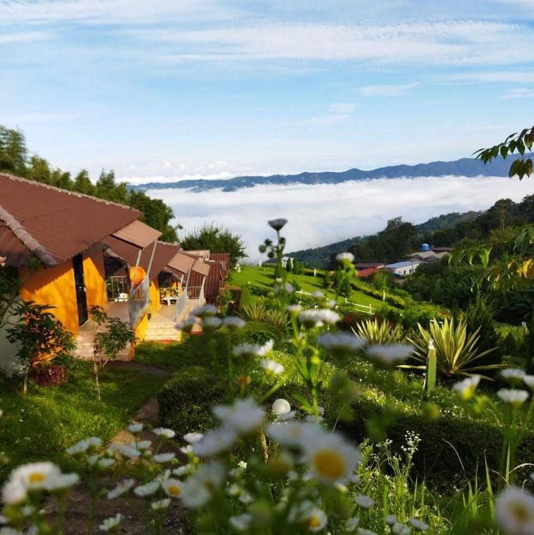a view of a garden with flowers in the grass at Phumokdokmai Resort in Ban Seng Choi