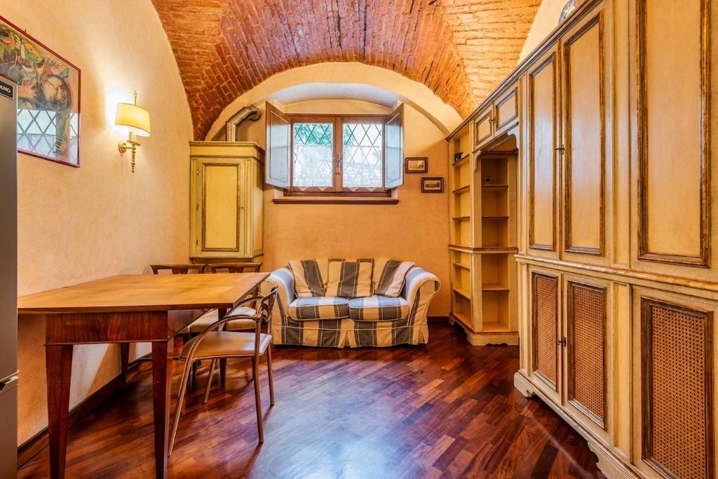 a living room with a table and a couch at Affreschi and Vintage Charm in Bergamo