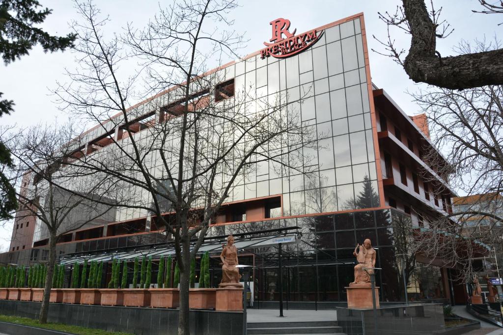 a building with a sign on the side of it at Hotel Presidivm Palace in Lovech