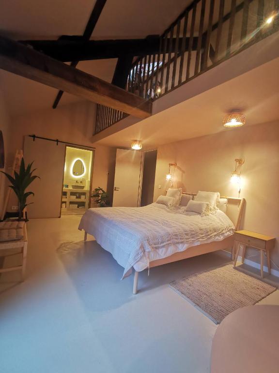 a bedroom with a large bed and a staircase at Mera Luxe Wellness B&B, Ibiza-Bohemian Style Suites, Adults Only, optioneel prive Outdoor Wellness, Massage, Vuurkorf, gratis fles Wijn of Bubbels in America