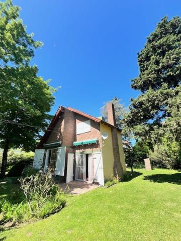 a small house in a grassy yard with trees at Las Marías qta in Arturo SeguÃ­