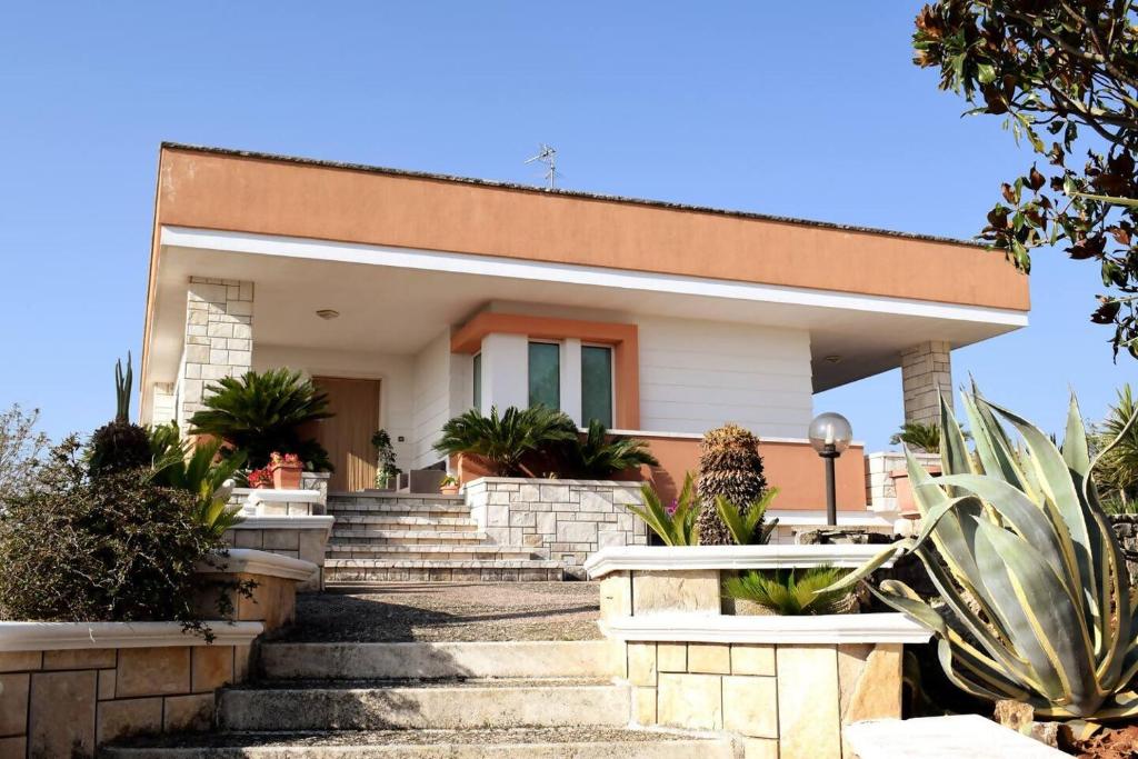 a house with stairs and plants in front of it at Valle holiday casa vacanza in Locorotondo