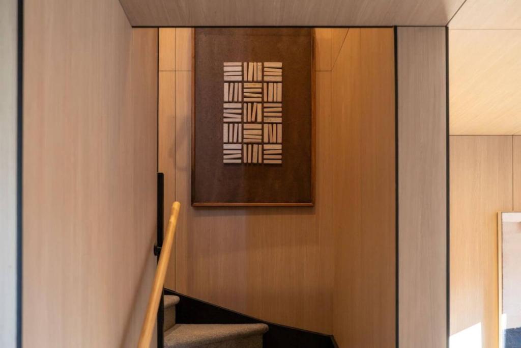 a stairway with a picture on the wall at Luxury Moea Villa Queenstown - with parking in Queenstown Airport