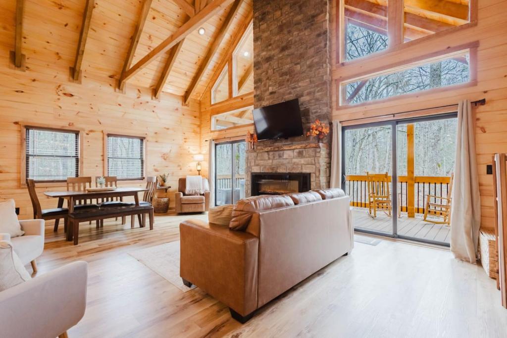 a living room with a couch and a fireplace at The Lazy Maple in Red River Gorge in Rogers