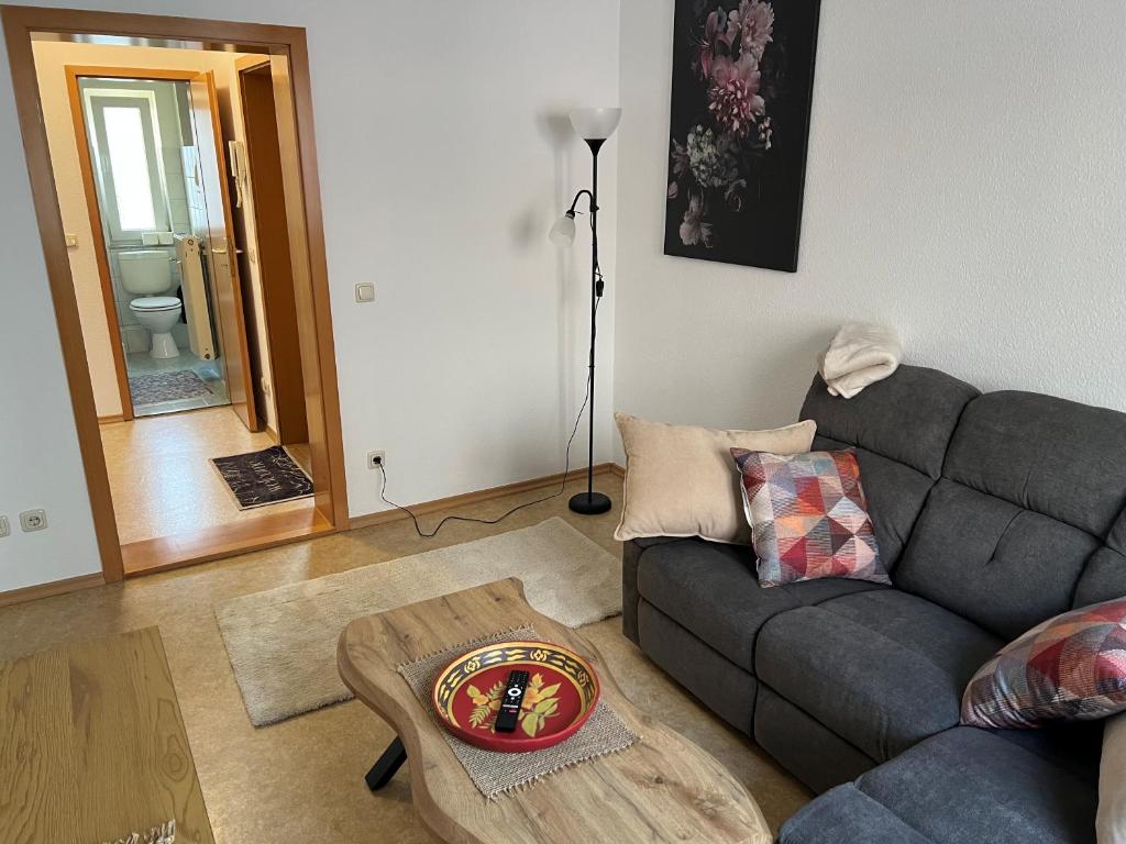 a living room with a couch and a coffee table at Ferienwohnung P5 in Schmölln
