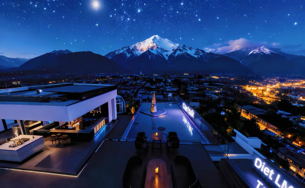 a view of a city at night with mountains at Shanyujin Dellar Wild Luxury Hotel Luxury Mountain Retreat in Lijiang