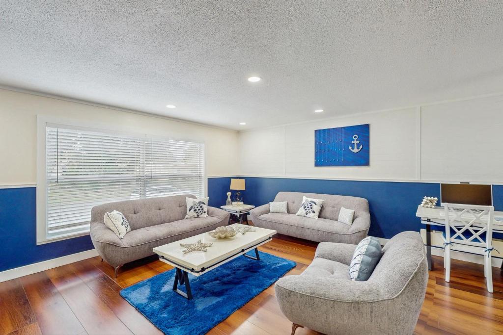 a living room with two couches and a table at Blue Boat House in Cocoa