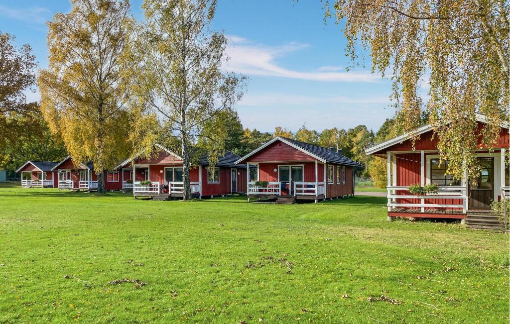 a row of red cottages in a park at Stunning Home In Byxelkrok With Wifi in Byxelkrok
