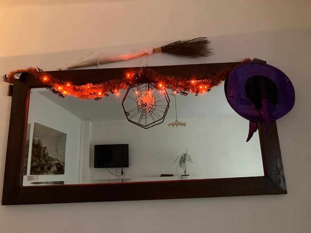 a mirror with christmas lights on a wall at Beach Road in Margate