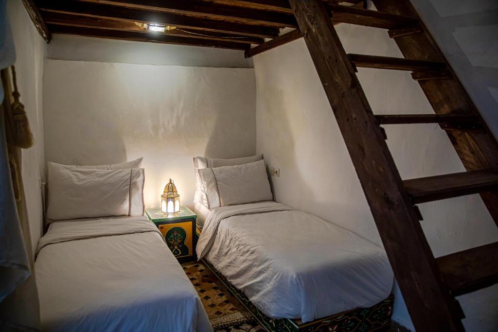 Ένα ή περισσότερα κρεβάτια σε δωμάτιο στο Dar Mohamadia