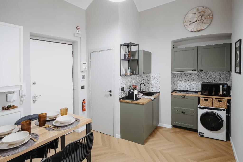 a kitchen with a table and a dining room at Mole Turin Suite in Turin