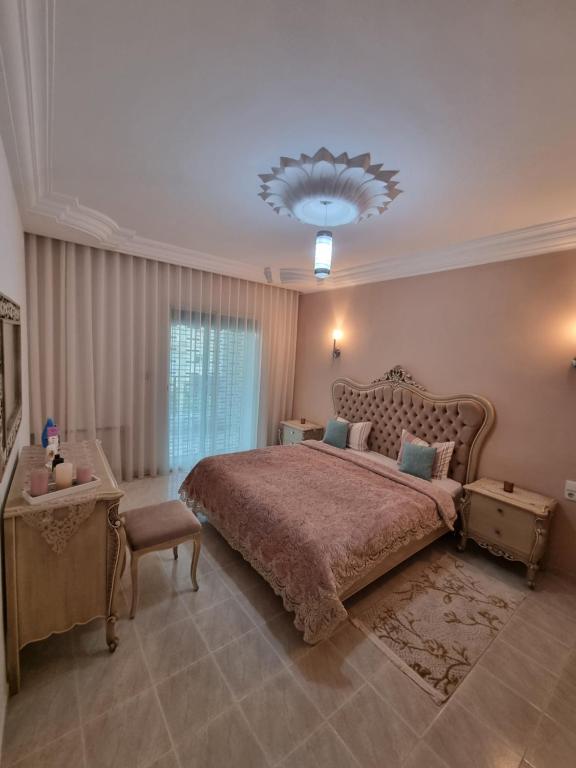 a large bedroom with a large bed and a chandelier at Ferienwohnung Nabeul in Douane