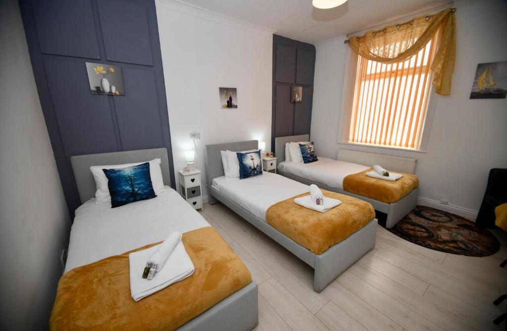 a small room with two beds and a window at The Lower Deck-South Shields 4 seperate beds sleeps 5 Contractor and Long Stay Rates in South Shields