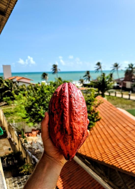 a person holding up a red object in their hand at O Rei Do Cumbuco - Cumbuco Residence in Caucaia