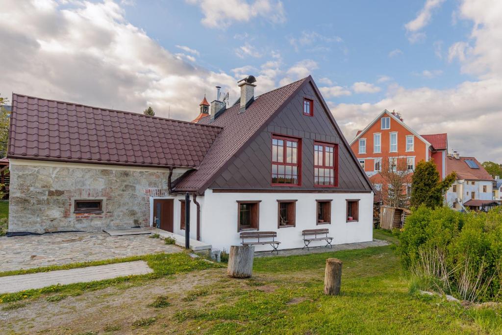 a large white house with a black roof at Chalupa Andrea in Abertamy