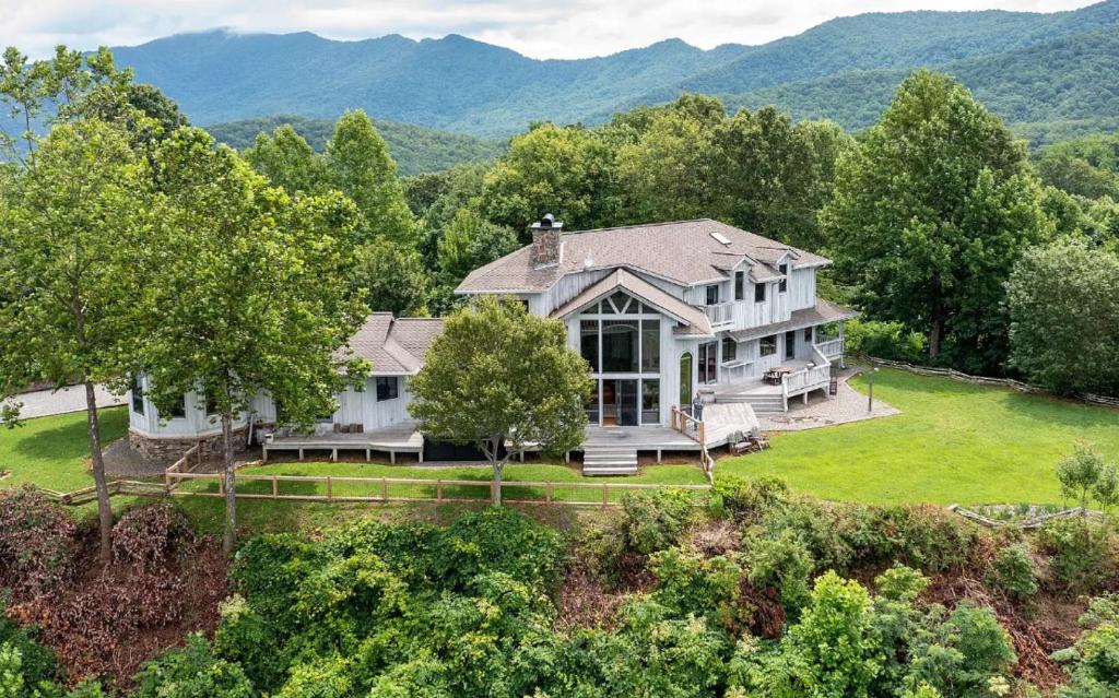 an aerial view of a large house with mountains in the background at Sunrise to Sunset in Hayesville