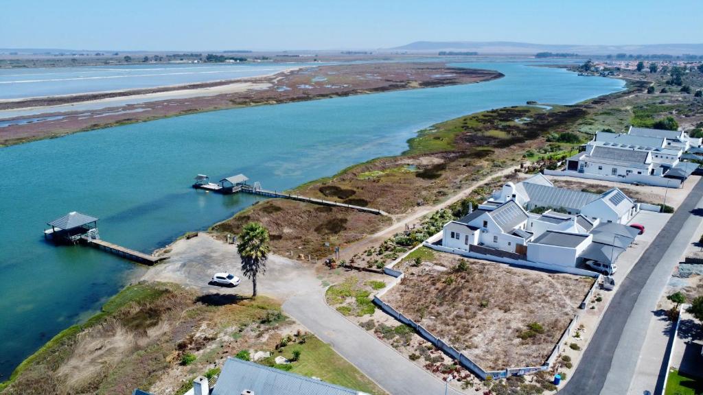 an aerial view of a house on an island in the water at Wild Riverside Cottage in Velddrif