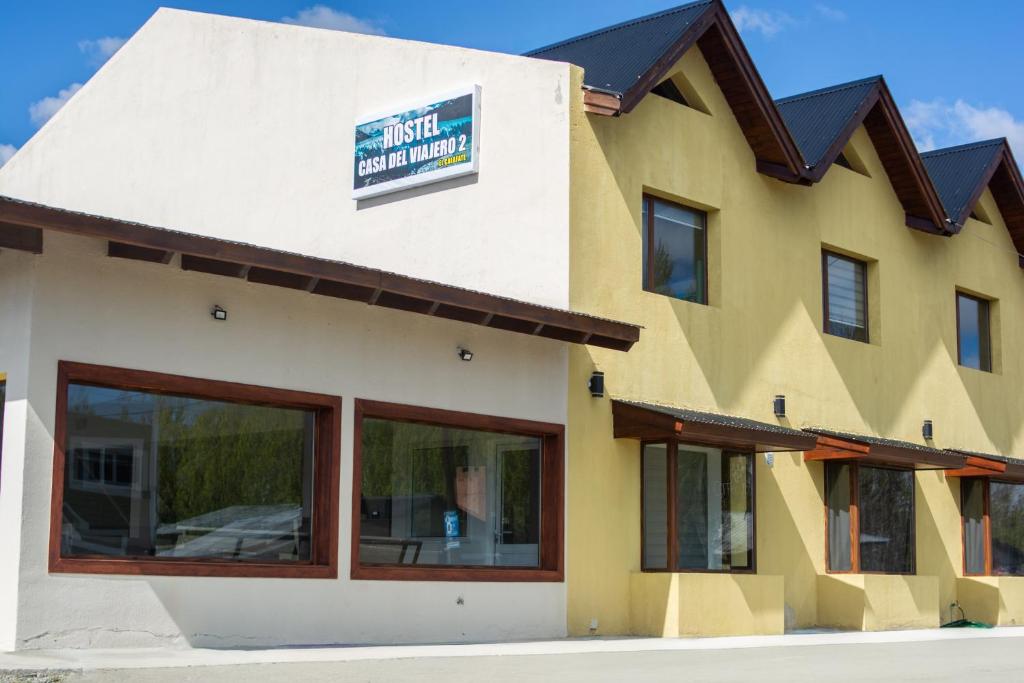 a building with a sign on the side of it at Hostel Casa del Viajero 2 in El Calafate