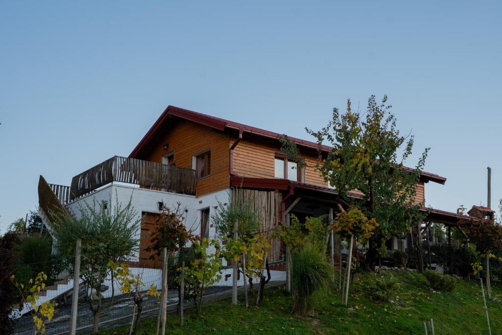 une maison en bois avec des arbres devant elle dans l'établissement Ruralna kuća za odmor KOVIN BREG, à Lepajci