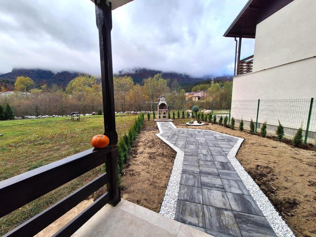 an outside view of a garden with a pumpkin on a fence at Mountain Place to Remember - River & Barbecue in Buşteni