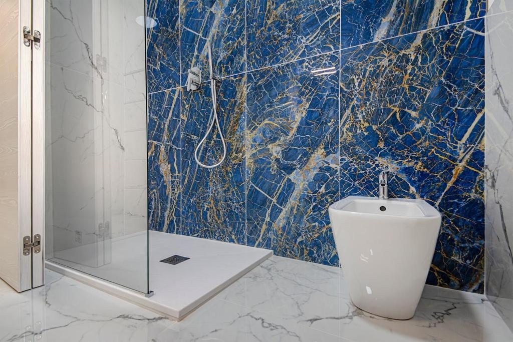 a bathroom with a toilet and a glass shower at Lovely Apartment 5 Minutes from Rho in Lainate