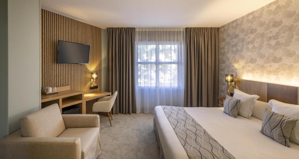 a hotel room with a bed and a desk at Best Western Plus Sanary in Sanary-sur-Mer