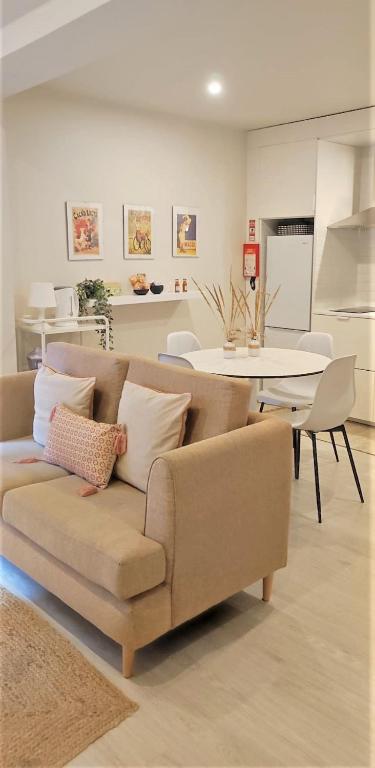 a living room with a couch and a table at Naty Studio with Terrace in Vila Nova de Famalicão