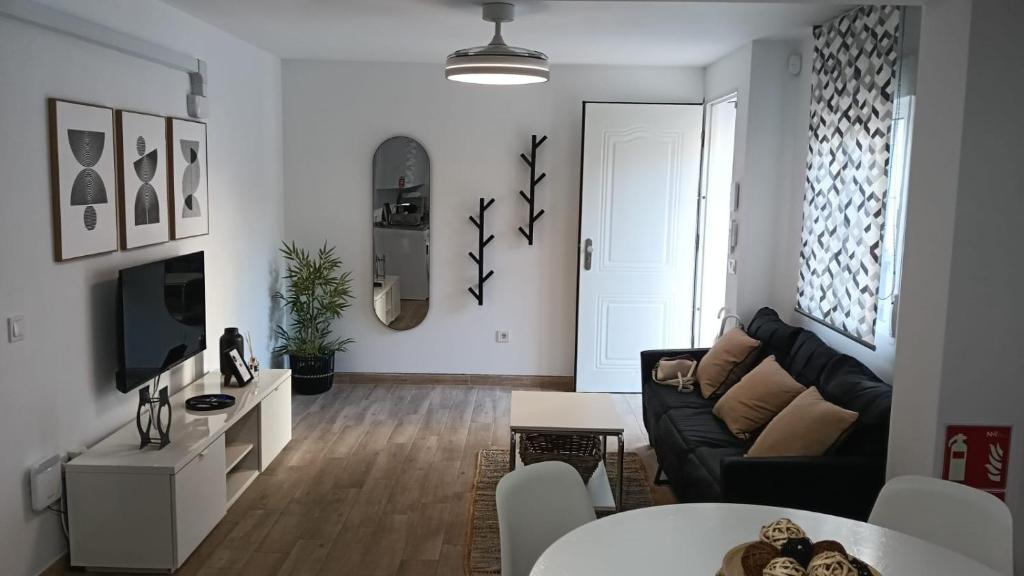 a living room with a couch and a table at Casa Los Naranjos in Marbella