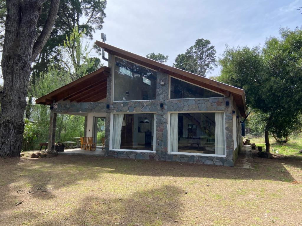 a house with a large window and a tree at Casa en Costa Del Este in Costa del Este