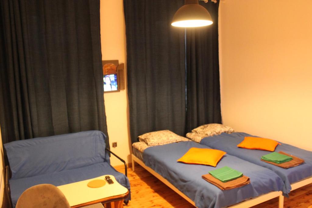 two beds in a room with black curtains at Szczecin Prawobrzeże Apartament Zajazd in Szczecin