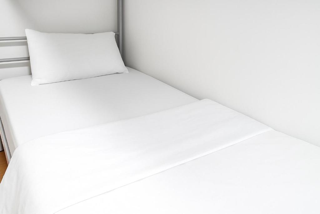 Postel nebo postele na pokoji v ubytování The Mini Homes Dorm Near Metro station