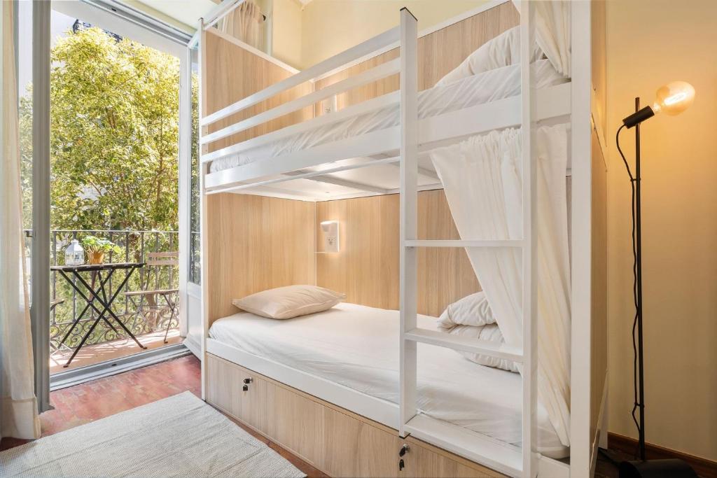 a bunk bed in a room with a window at Hostel Anguita in Madrid