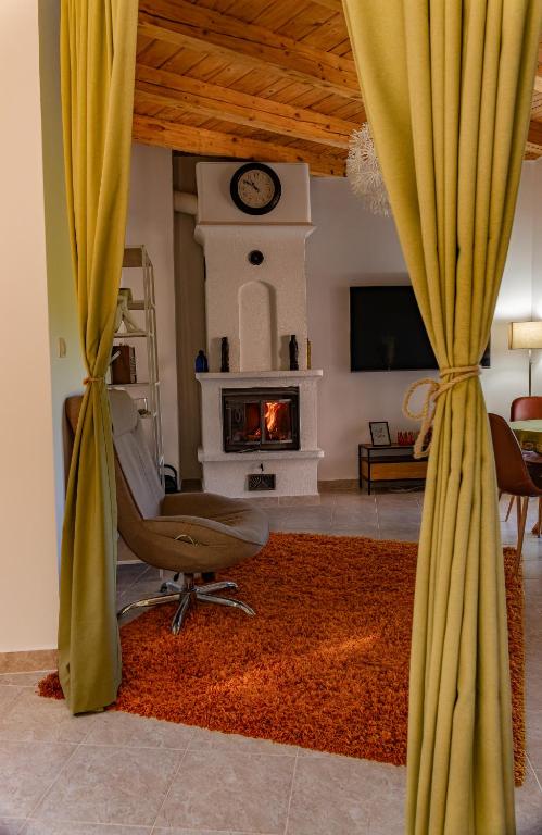 a living room with a chair and a fireplace at Best View Kolasin in Kolašin