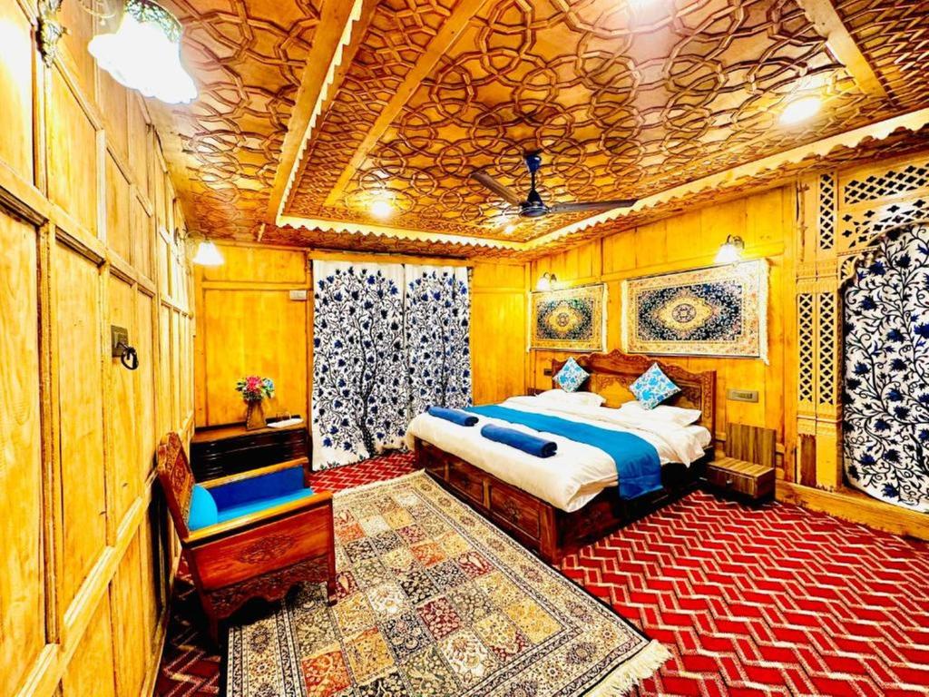 a bedroom with a bed in a room at Floating Luxury Group Of Houseboats in Srinagar